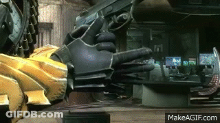 A Person Is Holding A Gun In Their Hand In A Room . GIF