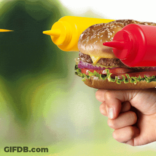 A Person Is Holding A Hamburger With Two Bottles Of Mustard And Ketchup GIF