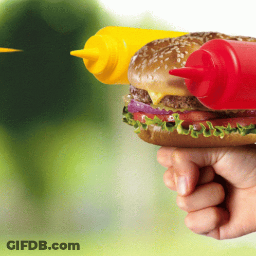 A Person Is Holding A Hamburger With Two Bottles Of Mustard And Ketchup GIF