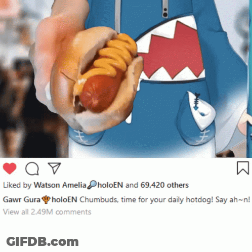 A Person Is Holding A Hot Dog With Cheese And A Picture Of A Shark Behind It GIF