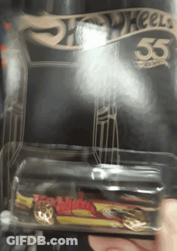 A Person Is Holding A Hot Wheels Car In A Plastic Container GIF