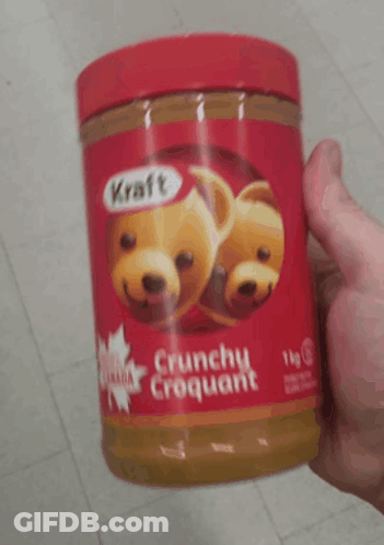 A Person Is Holding A Jar Of Kraft Peanut Butter GIF
