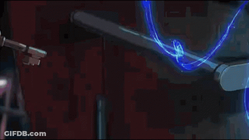 A Person Is Holding A Key That Is Surrounded By Blue Swirls GIF