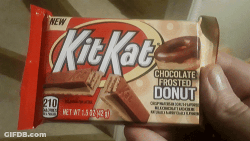A Person Is Holding A Kit Kat Chocolate Frosted Donut Bar GIF