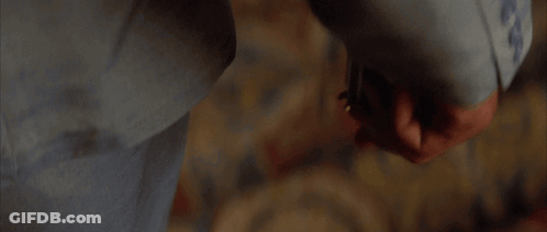 A Person Is Holding A Knife In Their Hand In A Blurry Photo GIF