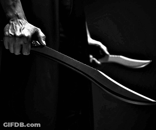 A Person Is Holding A Large Knife In Their Hand GIF