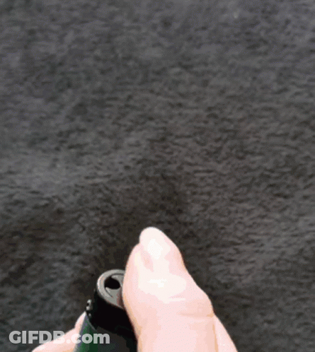 A Person Is Holding A Lighter With A Flame On It GIF