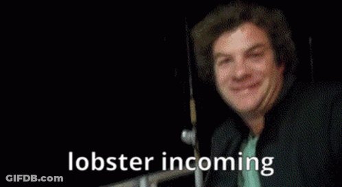 A Person Is Holding A Lobster With The Words Lobster Incoming Written Below It GIF