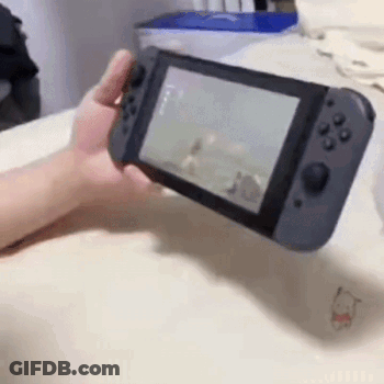 A Person Is Holding A Nintendo Switch In Their Hand And Playing A Video Game . GIF