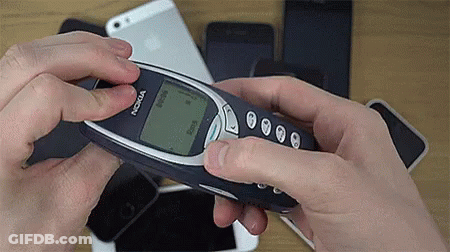 A Person Is Holding A Nokia Cell Phone In Their Hand GIF