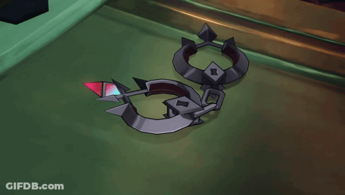A Person Is Holding A Pair Of Handcuffs With A Red Diamond In The Middle GIF
