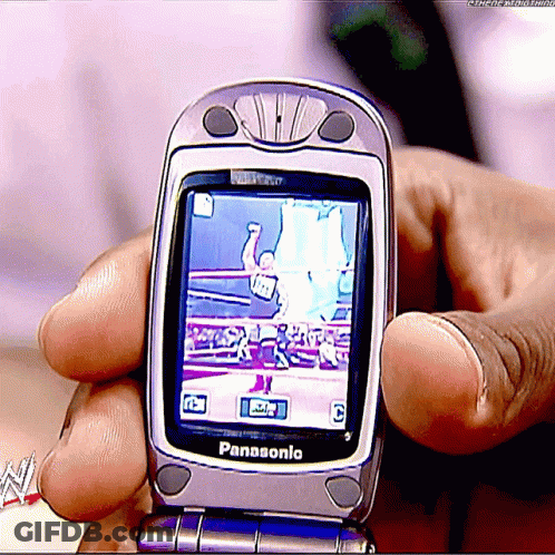 A Person Is Holding A Panasonic Flip Phone In Their Hands GIF