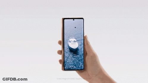 A Person Is Holding A Phone That Has A Boat On The Screen GIF