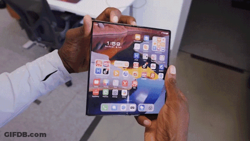 A Person Is Holding A Phone That Says 1:58 On It GIF