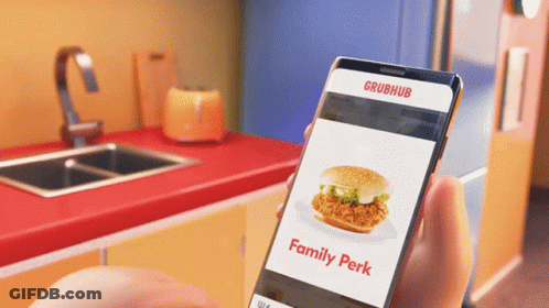 A Person Is Holding A Phone That Says Grubhub On The Screen GIF
