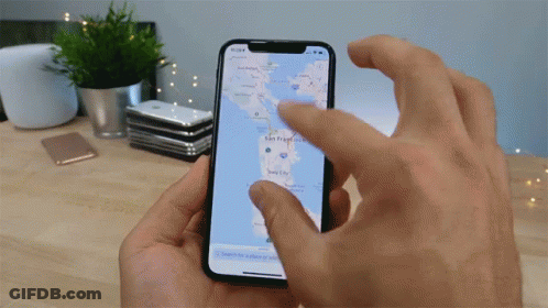 A Person Is Holding A Phone With A Map On It GIF