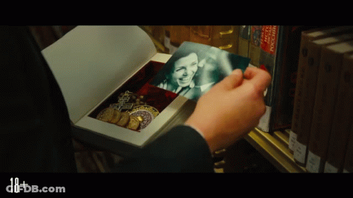 A Person Is Holding A Picture Of A Woman In A Box With The Number 18+ On The Bottom GIF