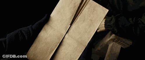 A Person Is Holding A Piece Of Paper In Their Hand GIF