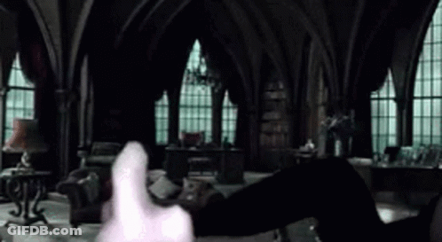 A Person Is Holding A Piece Of Paper In Their Hand In A Dark Room . GIF