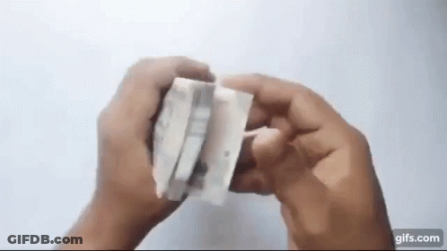 A Person Is Holding A Piece Of Paper That Looks Like A Piece Of Tissue Paper . GIF