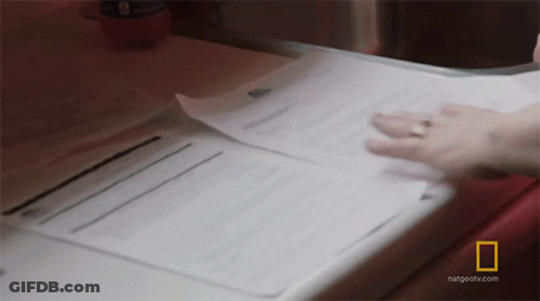 A Person Is Holding A Piece Of Paper That Says National Geographic GIF