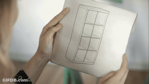 A Person Is Holding A Piece Of Paper With A Drawing Of A Shelf GIF