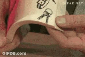 A Person Is Holding A Piece Of Paper With A Drawing Of Keys And A Watch On It GIF