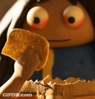 A Person Is Holding A Piece Of Tortilla Chips In Front Of A Cartoon Character With Big Eyes . GIF