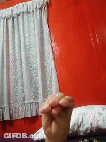 A Person Is Holding A Piece Of White Lace On A Red Table GIF