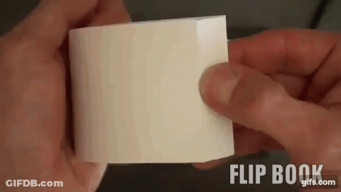 A Person Is Holding A Piece Of White Paper In Their Hands . GIF
