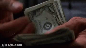 A Person Is Holding A Pile Of Money In Their Hands . GIF
