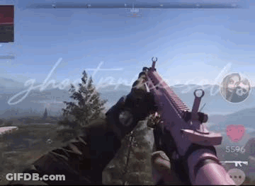 A Person Is Holding A Pink Gun In Their Hands In A Video Game . GIF
