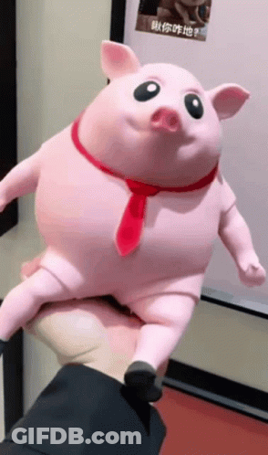 A Person Is Holding A Pink Pig With A Red Tie Around Its Neck GIF