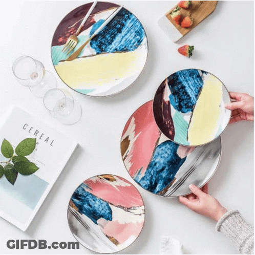 A Person Is Holding A Plate With A Fork On It . GIF