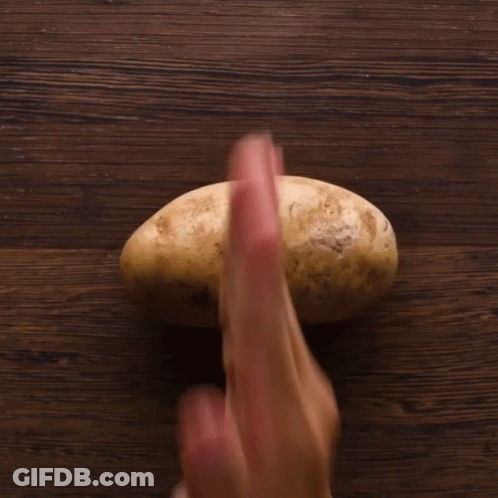 A Person Is Holding A Potato With Their Fingers GIF