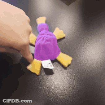 A Person Is Holding A Purple And Yellow Stuffed Animal With A Tag That Says Mcdonalds On It GIF