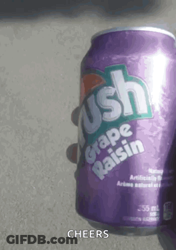 A Person Is Holding A Purple Can Of Grape Raisin Soda . GIF