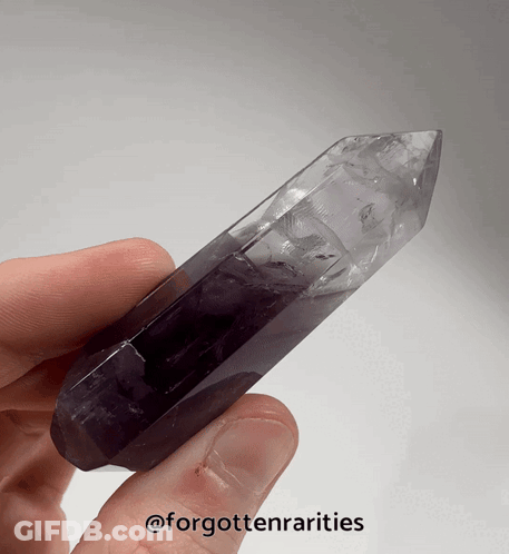 A Person Is Holding A Purple Crystal In Their Hand With The Words Forgottenrarities On The Bottom GIF