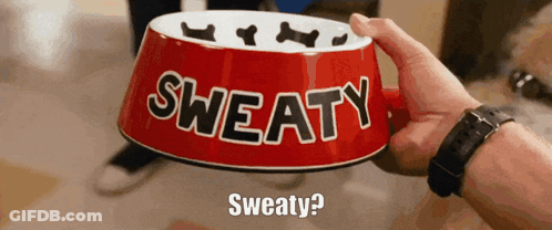 A Person Is Holding A Red Bowl That Says Sweaty On It GIF