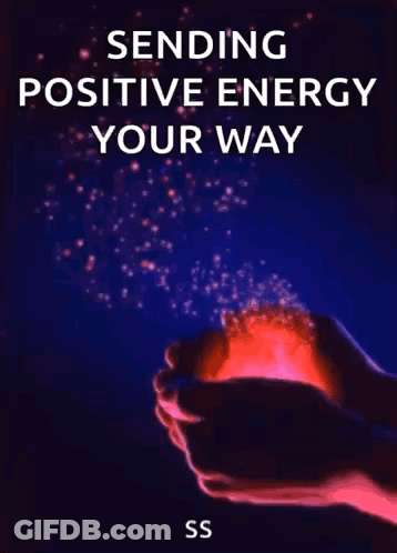 A Person Is Holding A Red Light In Their Hands With The Words `` Sending Positive Energy Your Way '' Written On It . GIF