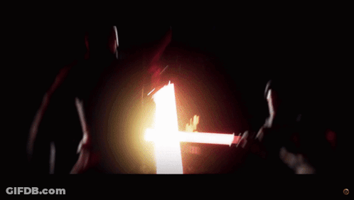 A Person Is Holding A Red Light Saber In Their Hand GIF