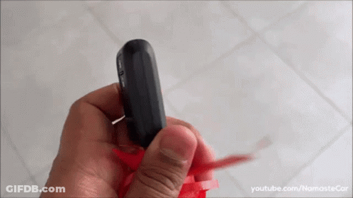 A Person Is Holding A Remote Control In Their Hand And The Video Is On Youtube.com/namastecar GIF