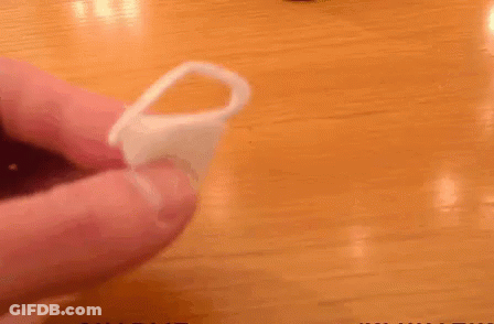 A Person Is Holding A Ring In Front Of A Pot That Says Charlie On It GIF