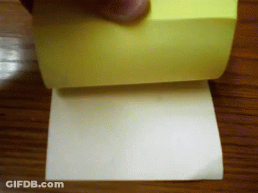 A Person Is Holding A Roll Of Sticky Notes GIF