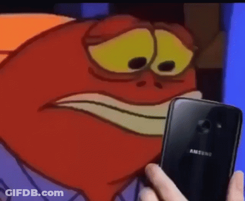 A Person Is Holding A Samsung Phone In Front Of A Cartoon Character 'S Face . GIF