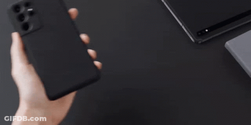 A Person Is Holding A Samsung Phone In Their Hand GIF