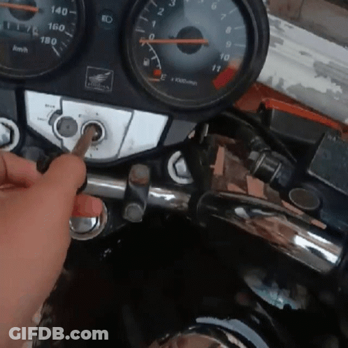 A Person Is Holding A Screwdriver In Front Of A Honda Dashboard GIF