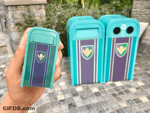 A Person Is Holding A Small Blue Trash Can With A Shield On It GIF
