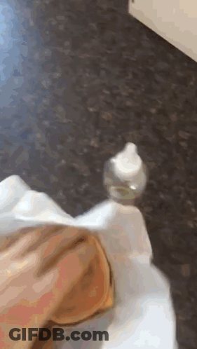 A Person Is Holding A Small Bottle On Their Foot GIF