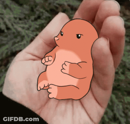 A Person Is Holding A Small Cartoon Animal In Their Palm GIF